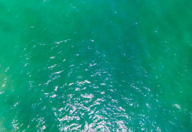 Aerial Drone photo. Beautiful turquoise green water background on summer sea beach. Relax and travel concept. Warm sunny weather.