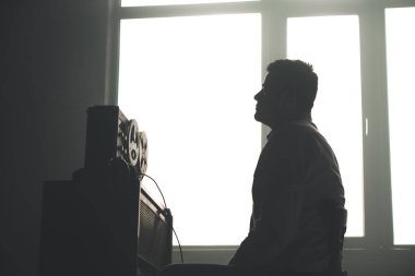 Gizli ajan kayıt cihazını dinliyormuş. Memur kulaklıkla dinleme yapıyor. Muhabbet casusluğu. İstihbarat toplama. Casusluk konsepti. Bilgileri üstlerinize bildirin.