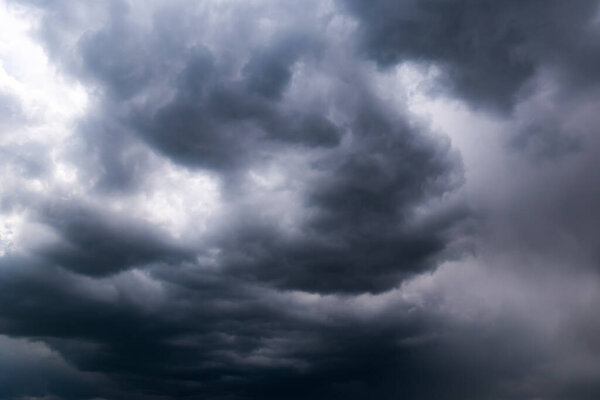 Beautiful thunderclouds. Beautiful dramatic blue sky background with fluffy dark clouds. Rainy weather.