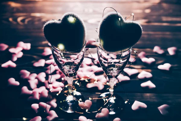 Hearts with wine glasses. Romantics love concept. Festive background. Valentines day postcard. Lights and lamps.