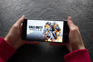 LVIV, UKRAINE - November 08, 2022 : Playing mobile game Call of Duty: Mobile on modern smartphone.