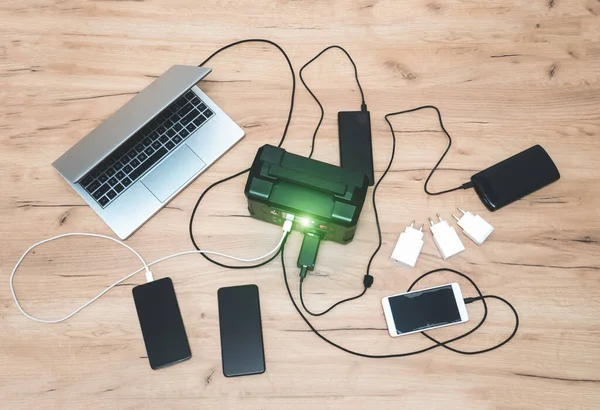 stock image lithium Portable Power Station is charging laptop smartphone