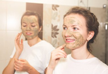 Girls are making clay masks for skin. Beauty procedures at home. Hen party.