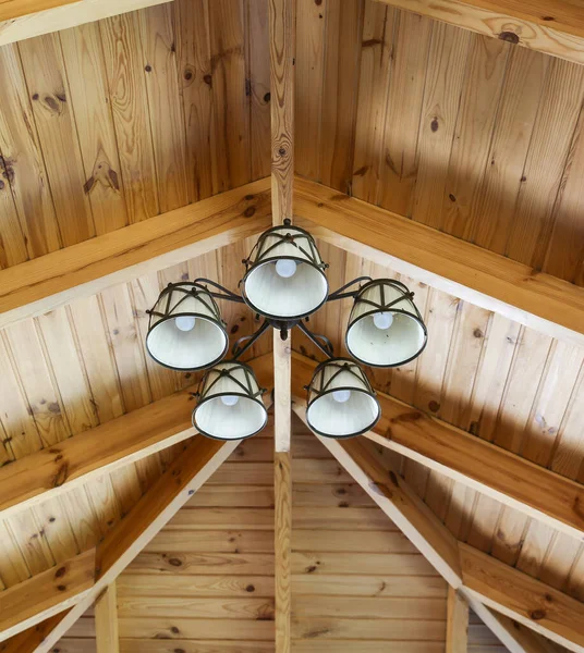 Wooden ceiling in rustic style. Vintage lamps.