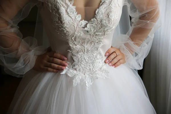 新娘把她的手放在腰部 漂亮的长袖连衣裙 蕾丝布 婚礼上午的细节 — 图库照片