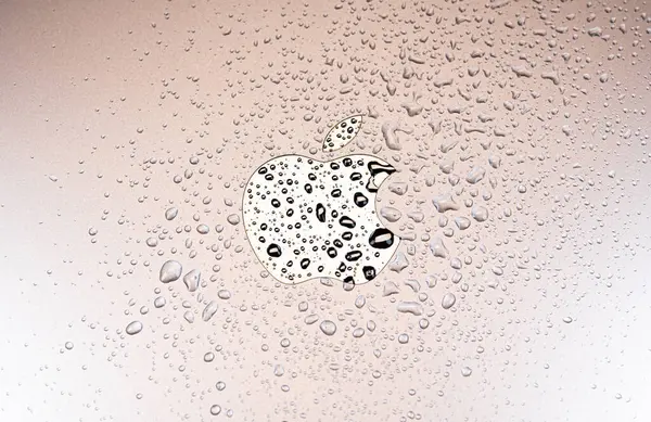 stock image KYIV, UKRAINE - October 03, 2023 : Black Apple logo with water drops. Water resistant modern technology.