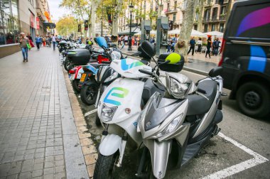 BARCELONA, SPAIN - OCTOBER 15, 2018: La Rambla street in Barcelona. Gothic square. City life. Motorbikes parking. clipart