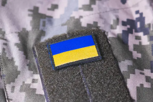 stock image Close up khaki camouflage amunition. Armed Forces of Ukraine. Ukrainian army. Ukrainian flag on military uniform.