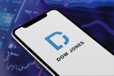 Karachi Pakistan - 12 Haziran 2023: Akıllı telefon ekranında Dow Jones logosu ve bulanık arka plandaki borsa grafiği.