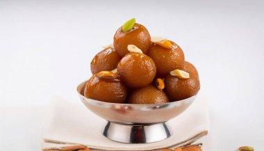 Gulab jaman with nuts syrup. Ai Generated clipart