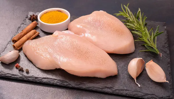 stock image Fresh Raw chicken cutlet breast fillets on a wooden board, fowl meat. Wooden background. ai generated