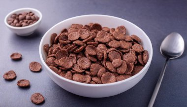 Chocolate cereals in white bowl. Chocolate flavored corn flakes. Wheat. Cocoa. Crispy. ai generated clipart