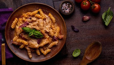 a delicious plate of pasta, likely fusilli, mixed with what appears to be pieces of chicken. ai generated clipart