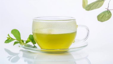 Cup with hot aromatic green tea on a Isolated background clipart