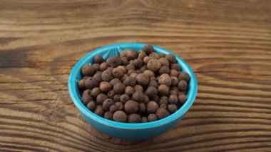 Allspice spice in a small bowl on the table