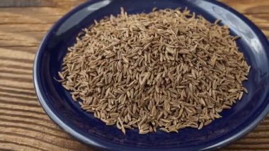 Aromatic roman cumin in a small bowl on the table