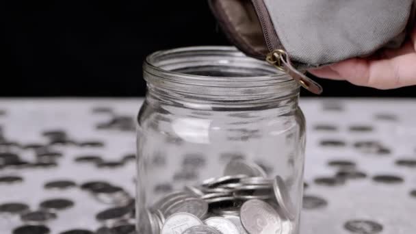 Woman Pouring Change Wallet Glass Jar Coins Piggy Bank Dalam — Stok Video