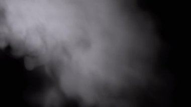 Icy White Foggy Cloud of Flying Steam on a Black Background. Abstract background. Bokeh effect. Thick fog and smoke fill the empty space. Blurred focus. Ice cloud steam. Floating mist. Slow-motion.