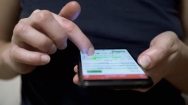 Trader Viewing Cryptocurrency Chart on Touchscreen in Mobile Phone. Businesswoman touches smartphone screen with finger. Chart of growth, fall of crypto for the month, day. Stock exchange data in app.