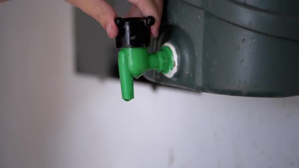 子供の手が開き プラスチック洗面台の汚れた古い水の蛇口を閉じます 容器から水の薄い流れが注ぐ 水の節約と消費 スローモーション — ストック動画