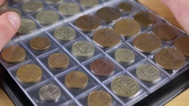 Eski Sovyet Bozukluklarıyla Numismatik Albümün Sayfalarına Dokunan Eller. Kapatın. Bir koleksiyoncu bir albümde antika para koleksiyonunu inceler. Hobi olarak. Bozuk para topluyorum. Açık arttırma. Boş zaman. Bellek.