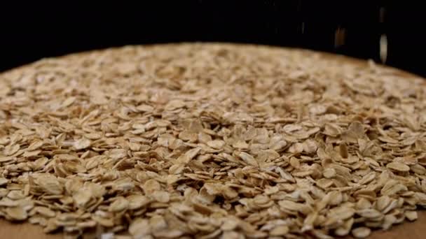 Dry Oat Flakes Falling Pile Raw Oatmeal Black Rotating Background — Stok Video