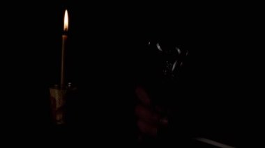 Yanan Mum 'un Arkaplanındaki Karanlık Oda' da Yanıp sönen Ampulü Tutmak. Edison tungsten parlak ampulü. Ilık ışık yanıp sönüyor. Enerji krizi. Kesinti. Elektrik kesintisi konsepti. Öde.