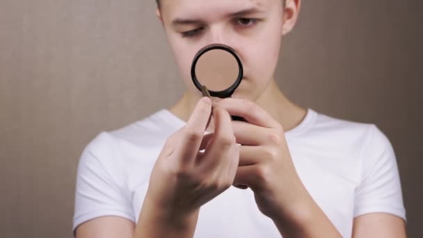 Close Teenager Examining Found Old Coin Magnifying Glass Curious Boy — Stock Video