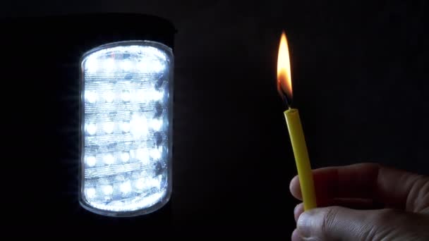 Hand Holds Burning Candle Switched Flashlight Black Background Inglês Fecha — Vídeo de Stock