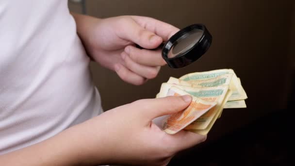 Tiener Onderzoekt Oud Oekraïens Geld Coupons Door Een Vergrootglas Handen — Stockvideo