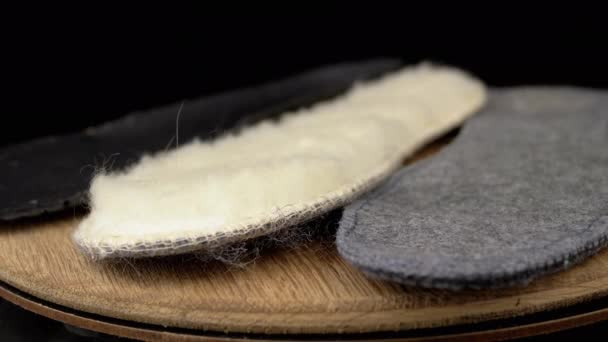 Close Warm Woolen Shoe Insoles Rotate Wooden Board Black Background — Stock Video
