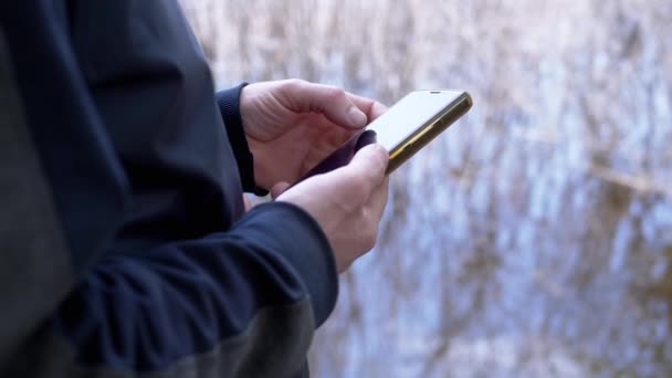 Hands Male Write Message Smartphone River Bank Nature Unrecognizable Person — Stock Video