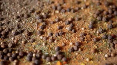 Değişen ahşap arka planda çeşitli çok renkli Hint baharatları serpiştirilmiş. Baharat, karabiber, kurutulmuş otlar, dereotu, paprika, zerdeçal, kekik. Yemek pişirmek için güzel kokulu baharatlar..