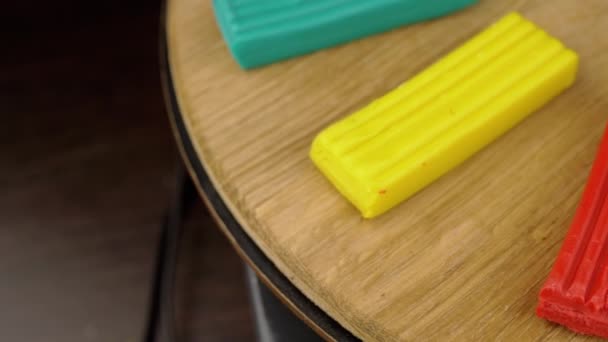 Multicolored Pieces Plasticine Rotate Wooden Surface Brown Background Zavřít Selektivní — Stock video