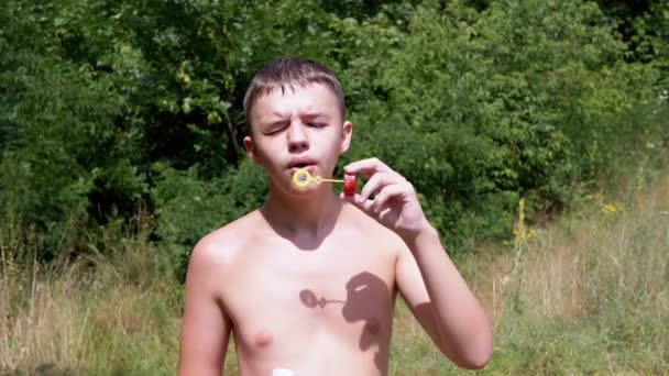 Boy Naked Torso Blowing Soap Bubbles Nature Rays Sunlight Close — Stock Video