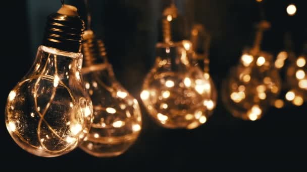 Hanging Glowing Vintage Edison Light Bulbs Smoke Black Background Warm — Stock Video