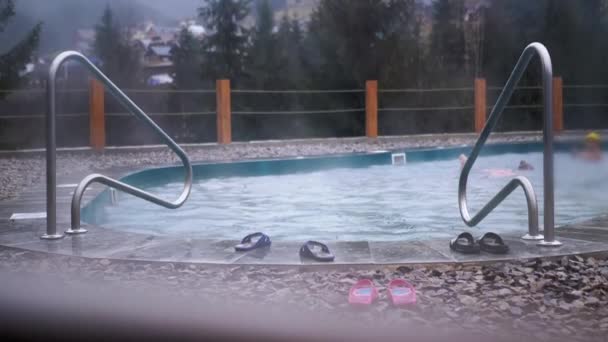 Adolescenti Nuotare Una Piscina Sotto Pioggia Sullo Sfondo Delle Montagne — Video Stock