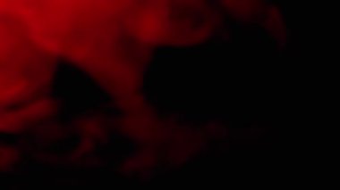 Yumuşak Duman Kırmızı Puff 'ları ya da Bulanık Arkaplanda Kara Arkaplanda Toz' u eritmek. Yan görüş. Plazma etkisi. Kırmızı yumuşak duman veya buhar kaotik bir şekilde boş uzayda karışıyor. Yavaş çekim.