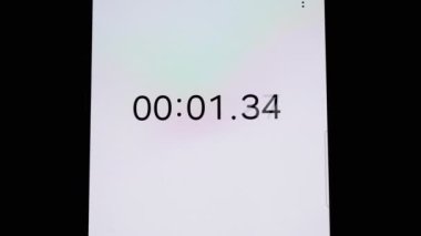 Dijital kronometre, zamanla, sporla ve fitness ile ilgili projeler için ideal bir akıllı telefon ekranında yer alır. Temiz beyaz arkaplan metin veya grafik örtüşmeleri için geniş bir alan sağlar.