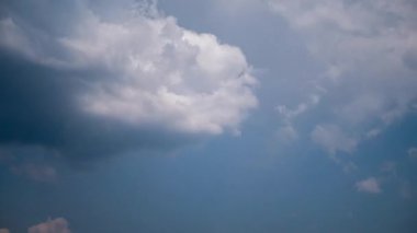 Dramatic time-lapse of heavy storm clouds rolling away and dissolving, transforming dense grey overcast into bright clear blue sky, symbolizing new beginnings and optimism in a meteorological shift.