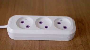 This is a demonstration showcasing how to plug various devices into a power strip that includes crucial safety features