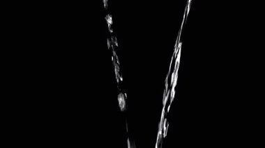 Two Streams of Water with Drops Pour into Empty Space. Black background. A transparent stream of water with streams joins into a funnel. Splashes, drops. Abstraction, texture, lighting. Slow motion.