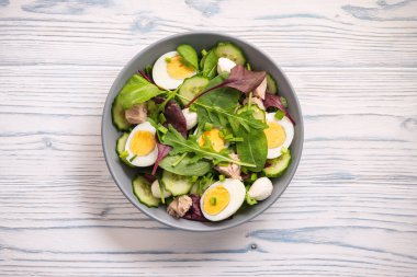 Keto dish - healthy green salad with arugula, tuna, mozzarella and eggs. 