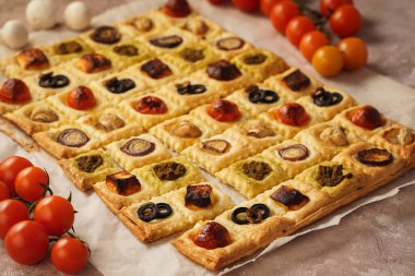 Puff pastry mini pies with cherry tomatoes, mushrooms, olives , feta cheese and onion.