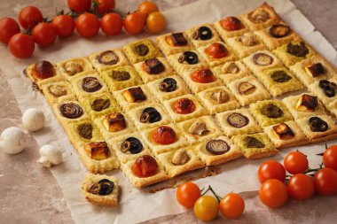 Puff pastry mini pies with cherry tomatoes, mushrooms, olives , feta cheese and onion.