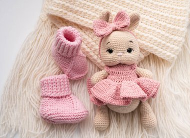 Variety of knitted toys. Bunny and baby booties. Handmade soft toys. clipart