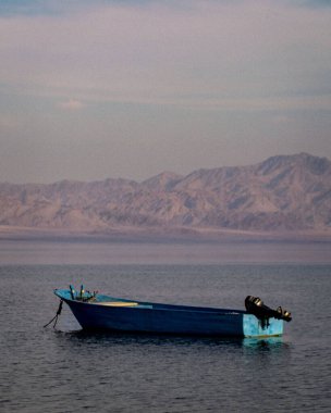 beautiful mountain view with a boat in the middle of sea 