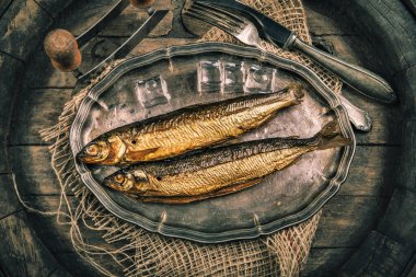 Smoked fish in a traditional way on a rustic background
