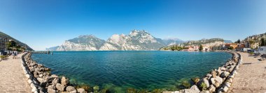 TORBOLE, ITALY-JULY 20, 2024: Torbole is located in the most picturesque, northern part of Lake Garda. On this side the lake is narrower and surrounded by high mountains. clipart