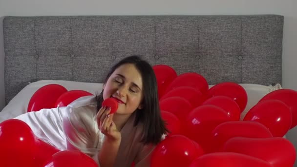 Woman Using Her Phone Eating Cookie Red Balloons Bed Girl — Wideo stockowe